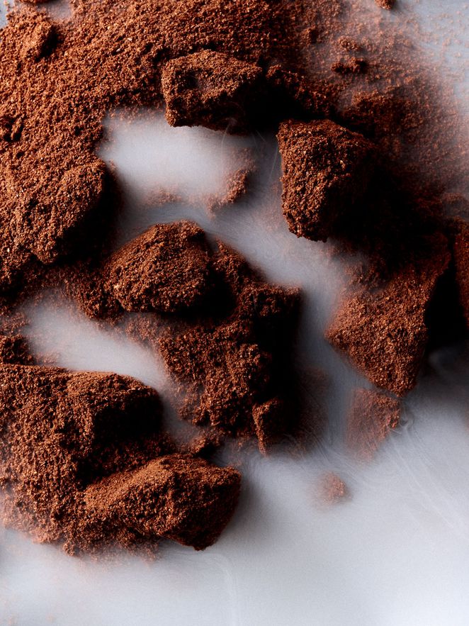 Nahaufnahme von grob gemahlenem Kaffeepulver mit aufsteigendem Dampf.