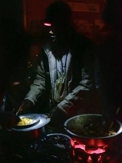 Eine Person mit Stirnlampe beim Kochen.